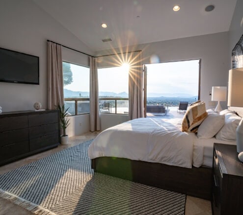Bedroom with sunlight shining through windows