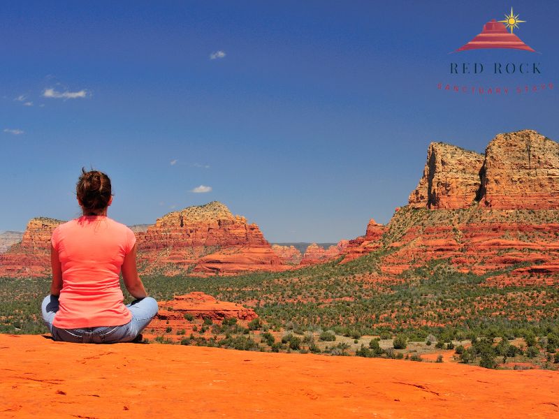 Person sitting on the red rocks of Sedona